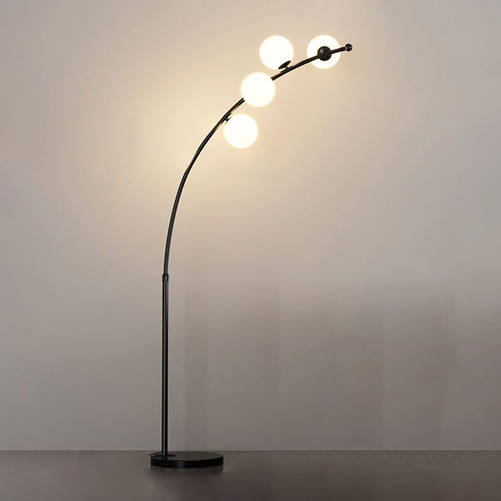 Zinco Arco – lampada arco nero sopra poltrona lettura